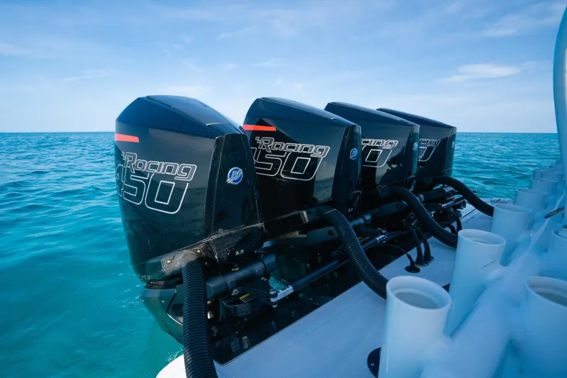 Slide: The Image of 2022 Nor-Tech 392 Super Fish with four powerful outboard engines on open water. - 26