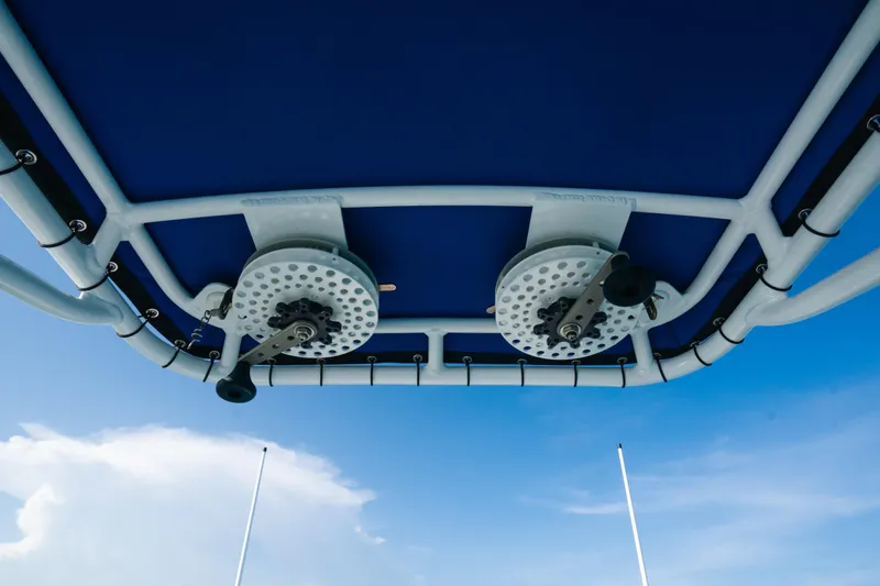 Slide: The Image of 2022 Nor-Tech 392 Super Fish boat canopy with fishing rod holders against blue sky. - 29