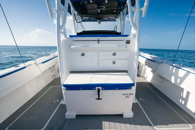 Slide: The Image of 2022 Nor-Tech 392 Super Fish boat interior with seating and storage, on open water. - 32