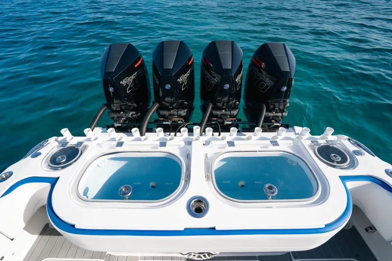 Slide: The Image of 2022 Nor-Tech 392 Super Fish boat with four powerful outboard engines on clear blue water. - 34
