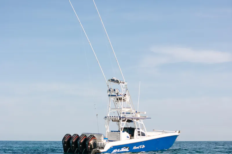 Slide: The Image of 2022 Nor-Tech 392 Super Fish boat on open water, featuring multiple outboard engines. - 41