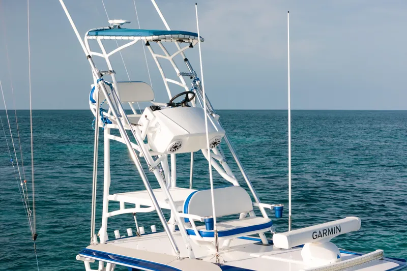 Slide: The Image of 2022 Nor-Tech 392 Super Fish boat with elevated helm, ocean backdrop. - 43