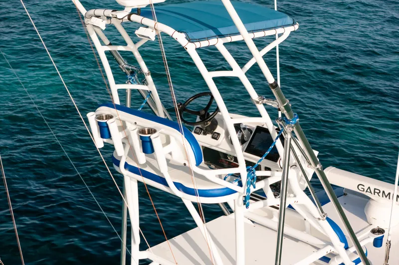Slide: The Image of 2022 Nor-Tech 392 Super Fish boat helm with blue accents on clear water. - 44