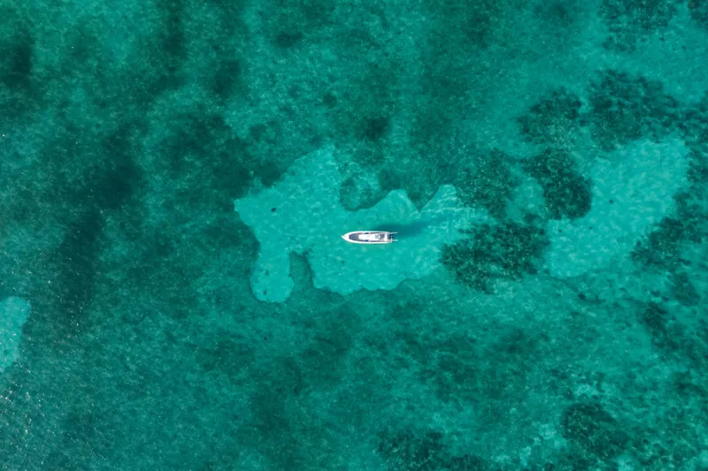 Slide: The Image of Aerial view of 2022 Nor-Tech 392 Super Fish boat on turquoise ocean waters. - 46