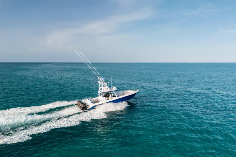 Slide: The Image of 2022 Nor-Tech 392 Super Fish boat cruising on open ocean under clear sky. - 47