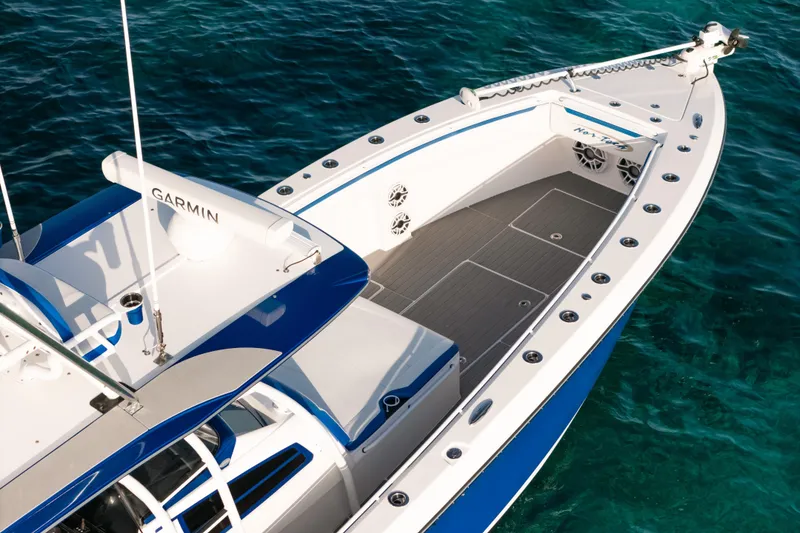 Slide: The Image of 2022 Nor-Tech 392 Super Fish boat on clear blue water, featuring Garmin equipment. - 7