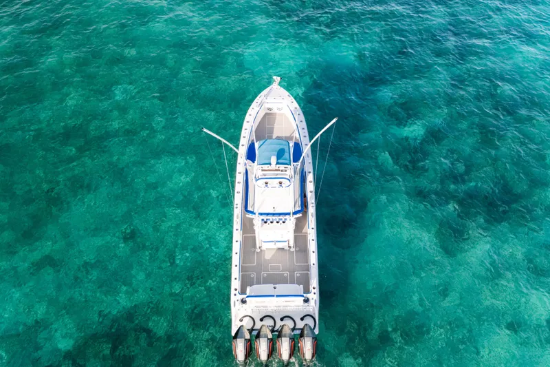 Slide: The Image of 2022 Nor-Tech 392 Super Fish boat on clear turquoise water, aerial view. - 9