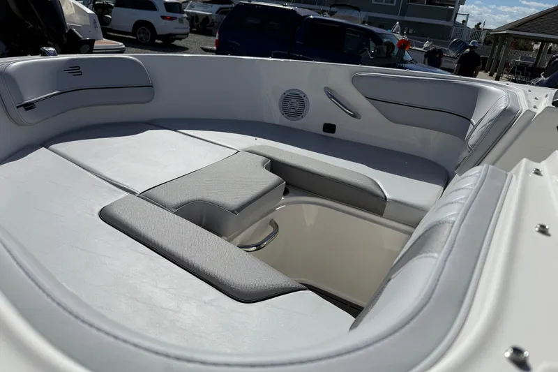 Slide: The Image of 2025 Bayliner VR4 Bowrider OB interior with cushioned seating and speaker system. - 3