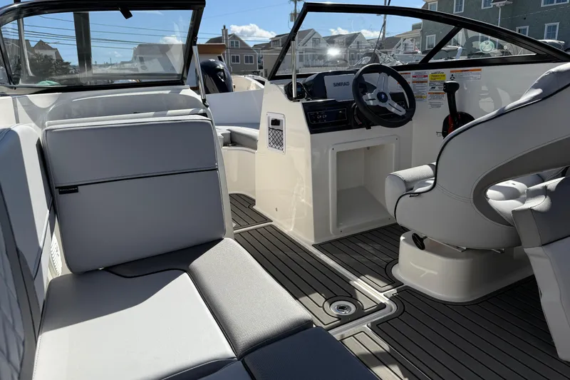 Slide: The Image of 2025 Bayliner VR4 Bowrider OB interior with modern seating and steering console. - 6