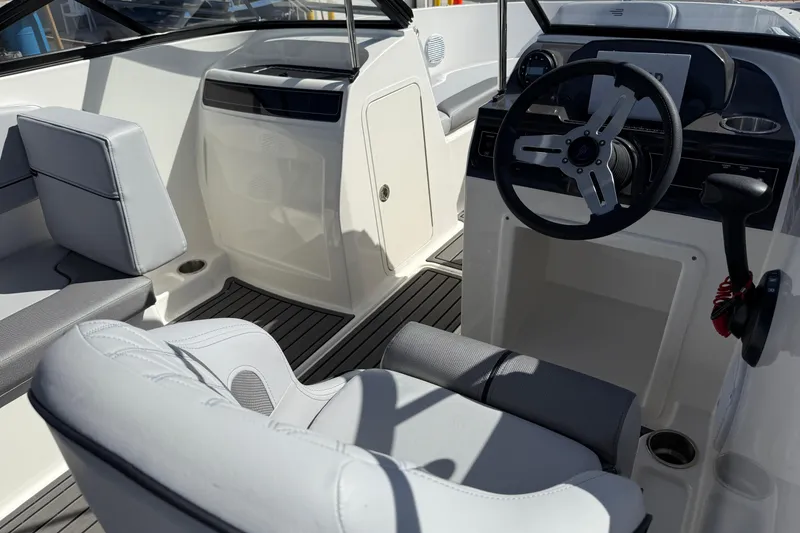 Slide: The Image of 2025 Bayliner VR4 Bowrider OB interior with steering wheel and seating. - 7