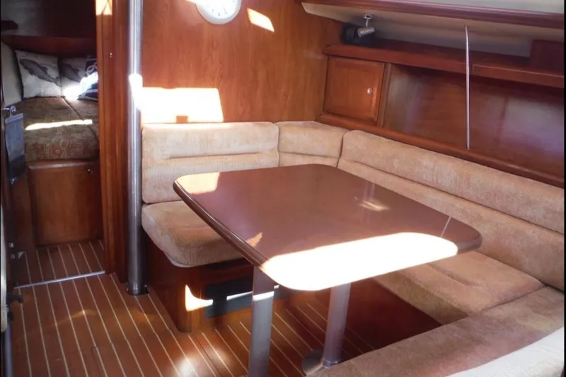 Slide: The Image of 2009 Hunter 38 sailboat docked at marina during sunset, featuring sleek white hull. - 10