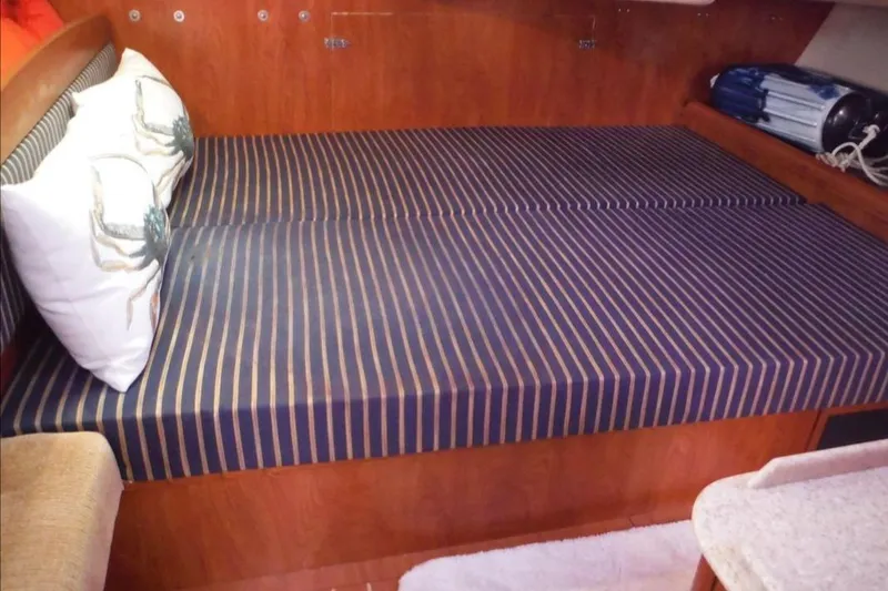 Slide: The Image of Interior of 2009 Hunter 38 sailboat with kitchen, stairs, and cozy cabin area. - 12