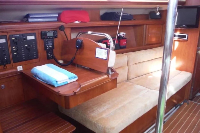 Slide: The Image of 2009 Hunter 38 yacht interior with kitchen, stairs, and cozy cabin space. - 13