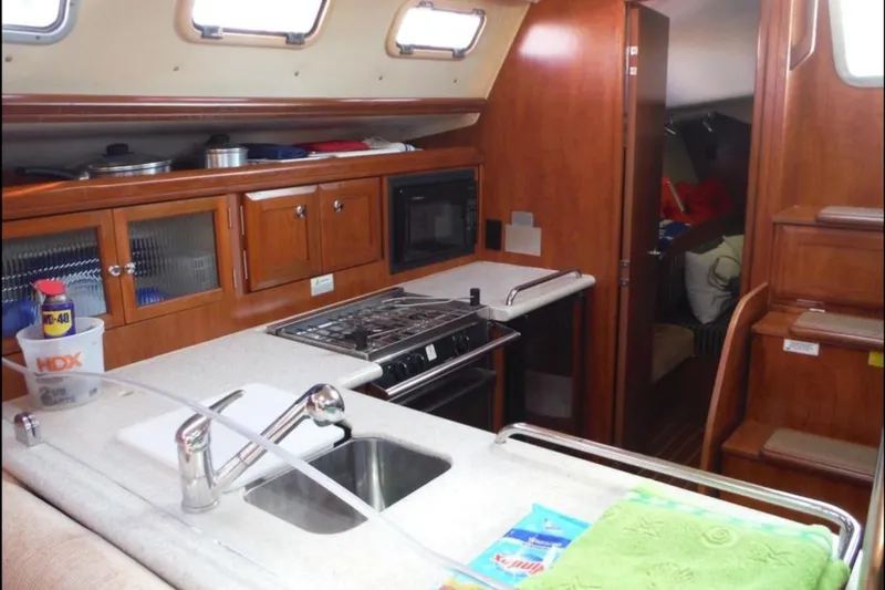 Slide: The Image of Interior of 2009 Hunter 38 sailboat with wood finish and cozy seating area. - 14