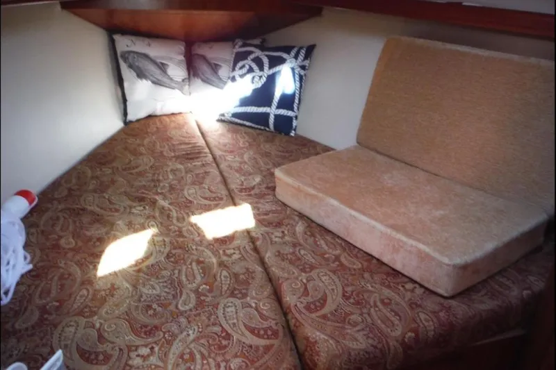 Slide: The Image of Interior of 2009 Hunter 38 sailboat with cozy seating and wooden finishes. - 17