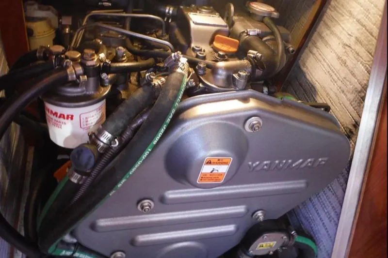 Slide: The Image of Cozy cabin interior of 2009 Hunter 38 sailboat with striped bedding and wooden finishes. - 20