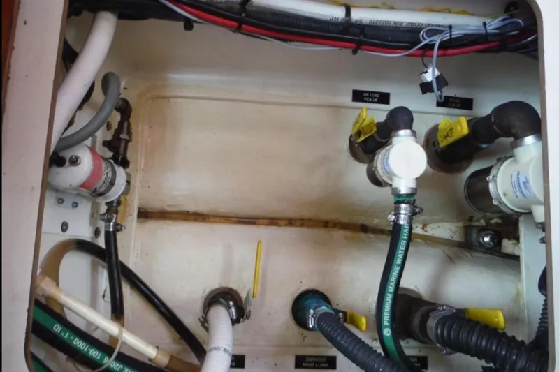 Slide: The Image of Interior of a 2009 Hunter 38 yacht with wooden shelves and beige seating. - 23