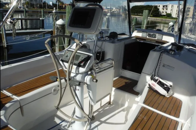 Slide: The Image of 2009 Hunter 38 sailboat docked at marina under clear blue sky. - 4
