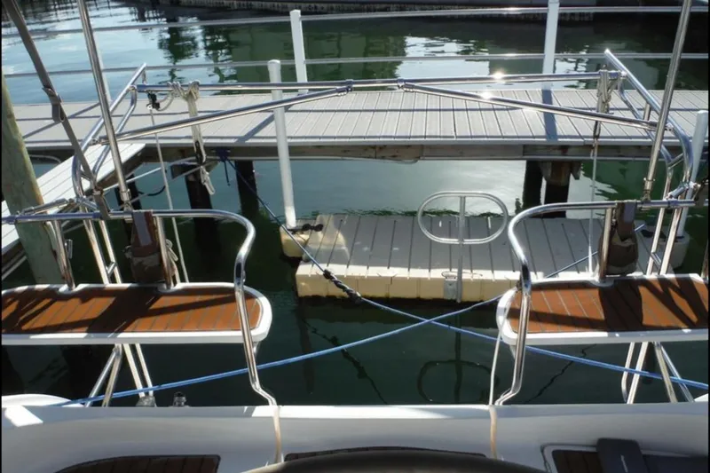 Slide: The Image of Tall masts of a 2009 Hunter 38 sailboat against a cloudy sky. - 6