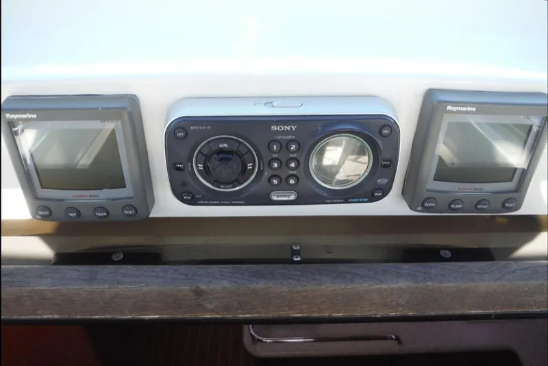 Slide: The Image of 2009 Hunter 38 sailboat docked with dinghy at sunset in marina. - 8