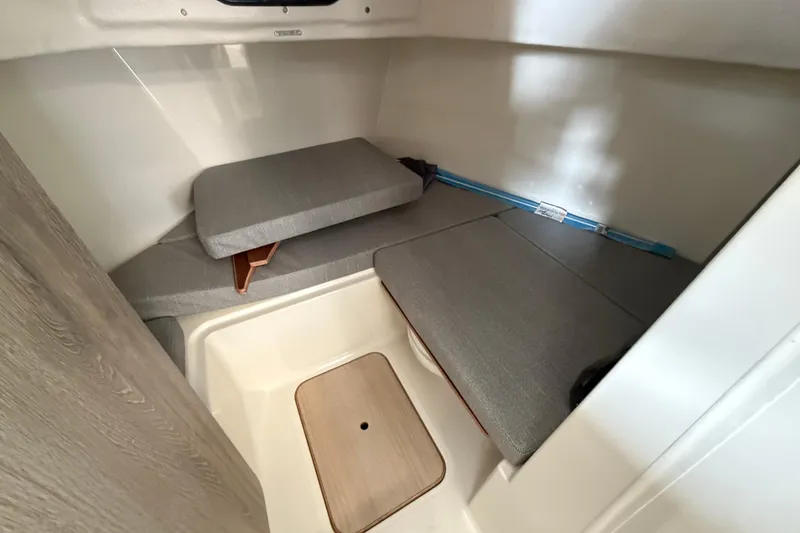 Slide: The Image of 2025 Bayliner Trophy T23 Pilothouse interior with compact marine toilet. - 10