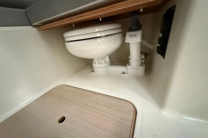 Slide: The Image of Interior of 2025 Bayliner Trophy T23 Pilothouse with two white captain's chairs. - 11