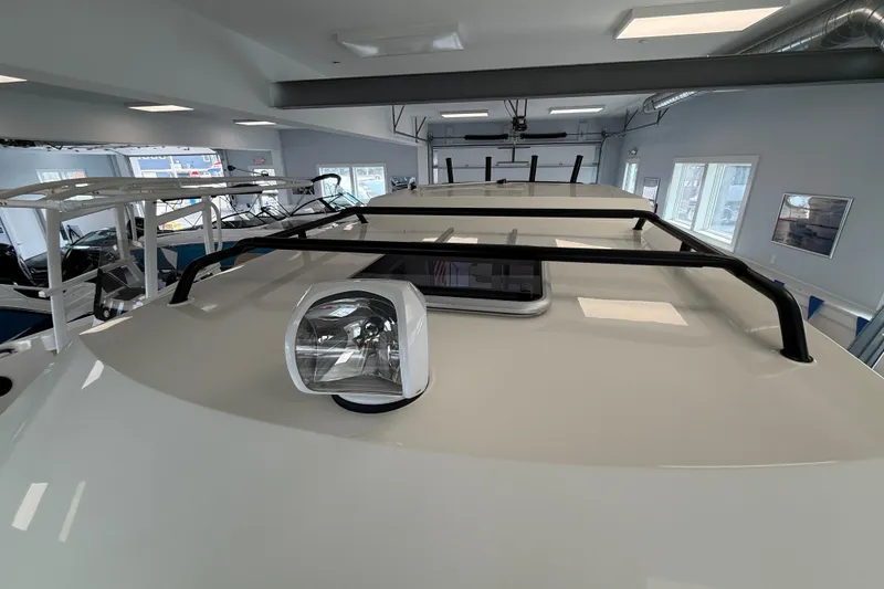 Slide: The Image of Interior of 2025 Bayliner Trophy T23 Pilothouse with two white captain's chairs. - 14