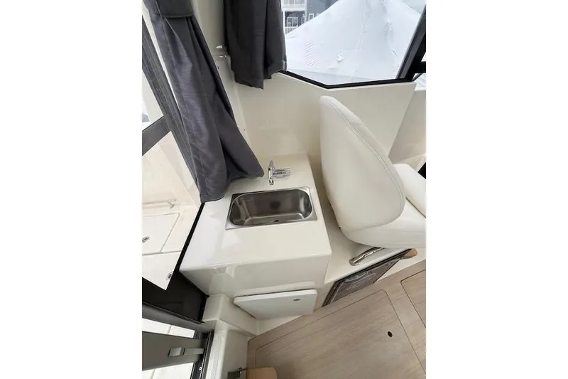 Slide: The Image of Interior of 2025 Bayliner Trophy T23 Pilothouse with sink and seating area. - 19