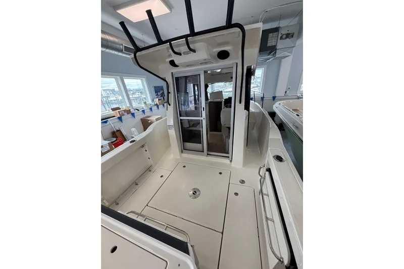 Slide: The Image of 2025 Bayliner Trophy T23 Pilothouse boat deck with storage compartments and seating. - 4
