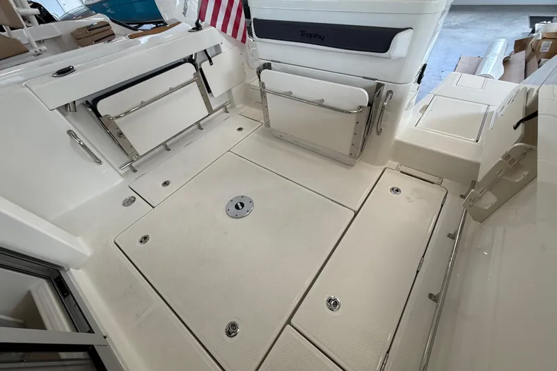 Slide: The Image of 2025 Bayliner Trophy T23 Pilothouse interior with helm, seating, and sink. - 5