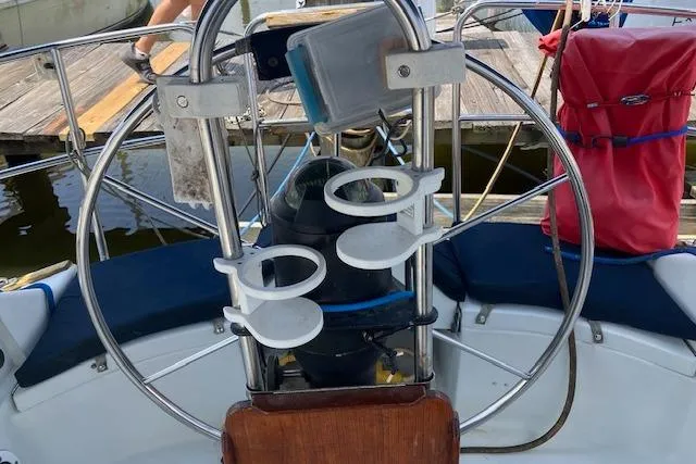 Slide: The Image of Cockpit of 1990 C&C 30-2 sailboat with steering wheel and cup holders. - 11