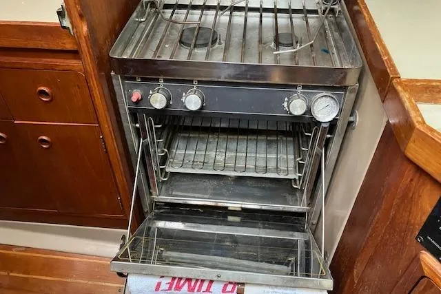 Slide: The Image of Stainless steel stove and oven in a 1990 C&C 30-2 sailboat kitchen. - 18