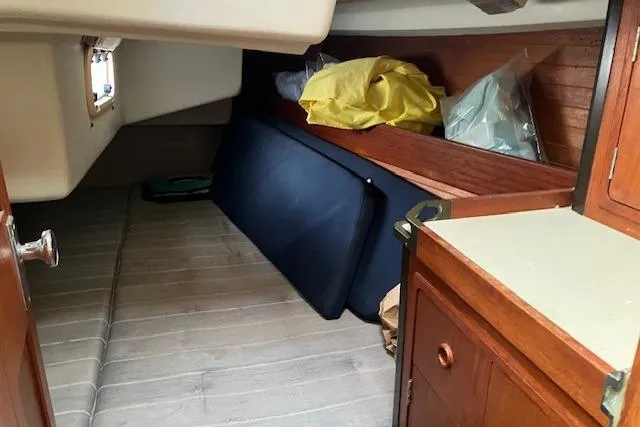 Slide: The Image of Interior cabin of 1990 C&C 30-2 sailboat with wooden cabinetry and storage space. - 20