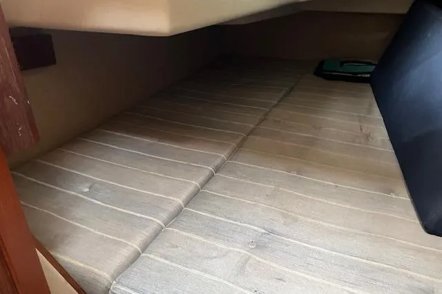 Slide: The Image of Interior cabin space of a 1990 C&C 30-2 sailboat, featuring a cushioned sleeping area. - 24