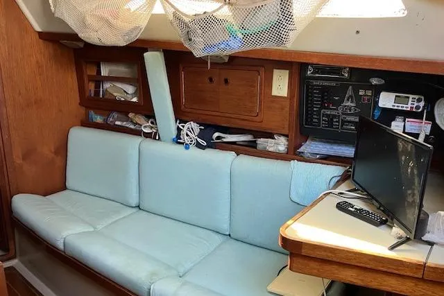 Slide: The Image of Interior of 1990 C&C 30-2 sailboat with blue seating and navigation equipment. - 25