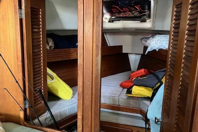 Slide: The Image of Interior cabin of 1990 C&C 30-2 sailboat with wooden finishes and life jackets. - 26