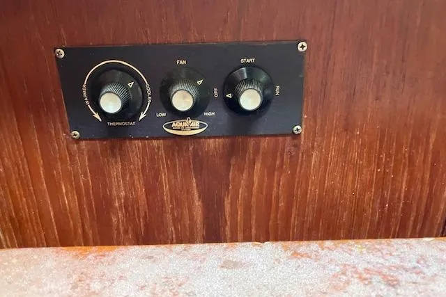 Slide: The Image of Control panel of Aqua-Air system on 1990 C&C 30-2 sailboat, featuring thermostat and fan settings. - 28