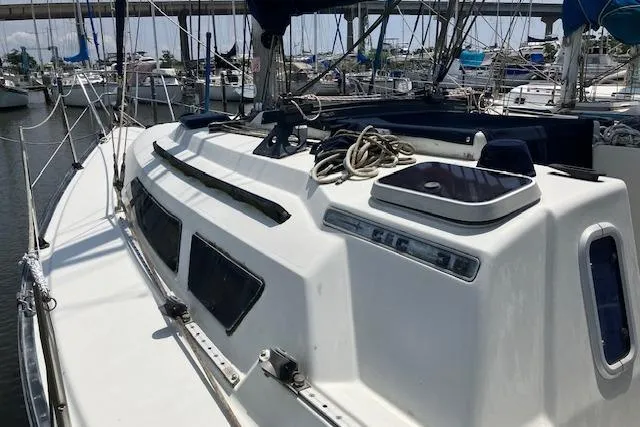 Slide: The Image of 1990 C&C 30-2 sailboat deck with ropes, docked in marina. - 4