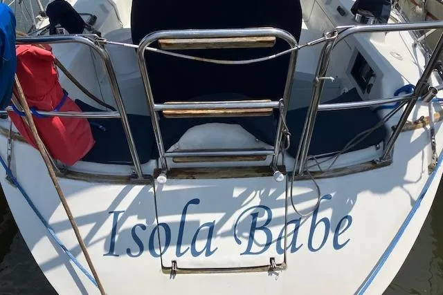 Slide: The Image of 1990 C&C 30-2 sailboat named "Isola Babe" with visible deck and railing. - 8