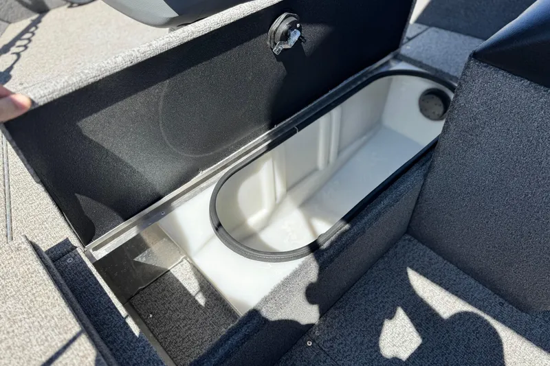 Slide: The Image of Open storage compartment in 2020 Alumacraft Escape 165 SC boat, showing interior details. - 13