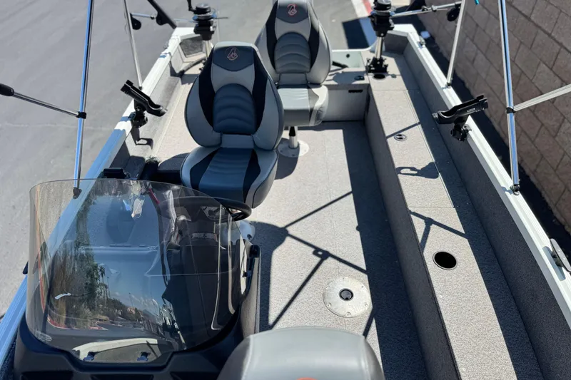 Slide: The Image of 2020 Alumacraft Escape 165 SC boat interior with seating and fishing rod holders. - 14
