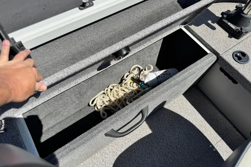 Slide: The Image of Storage compartment in 2020 Alumacraft Escape 165 SC boat with rope and fire extinguisher. - 20