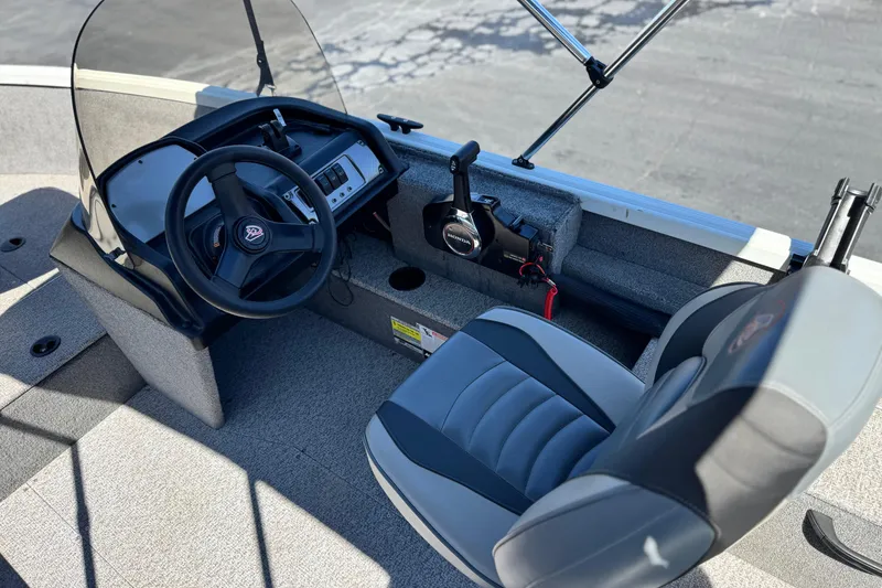Slide: The Image of 2020 Alumacraft Escape 165 SC boat interior with steering wheel and seating. - 21