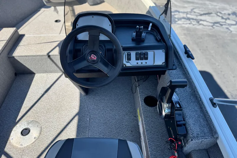 Slide: The Image of 2020 Alumacraft Escape 165 SC boat cockpit with steering wheel and control panel. - 22