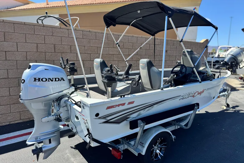 Slide: The Image of 2020 Alumacraft Escape 165 SC boat with Honda outboard motor and canopy. - 5