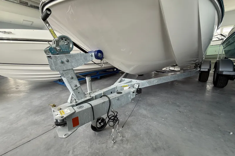 Slide: The Image of 2025 Bayliner Trophy T18 boat on trailer in showroom. - 11