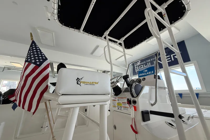 Slide: The Image of 2025 Bayliner Trophy T18 boat interior with American flag and Fishmaster accessories. - 12