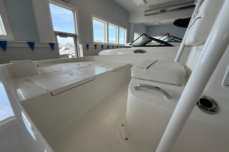 Slide: The Image of 2025 Bayliner Trophy T18 boat interior with seating and storage compartments. - 9