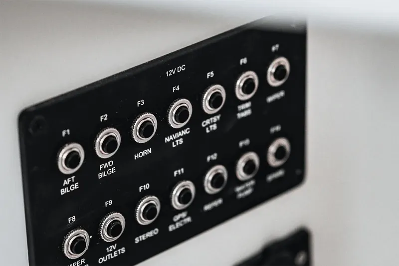 Slide: The Image of Manufacturer Provided Image: Control panel of 2025 Bayliner Trophy T25 Explorer boat with labeled switches. - 6