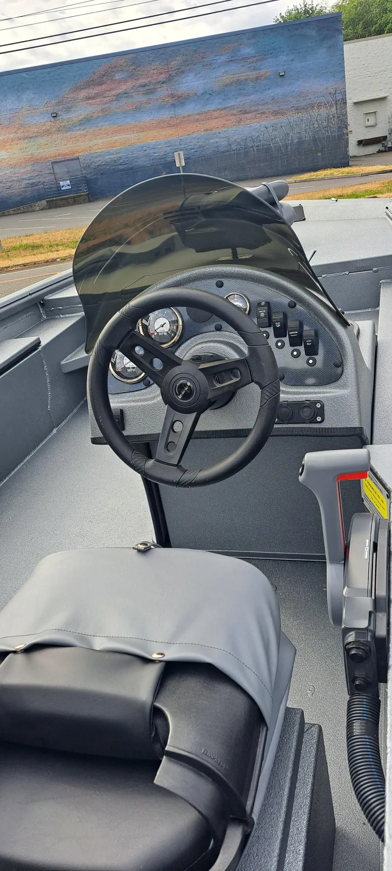 Slide: The Image of 2025 Excel 1860 Stalker SC boat interior with steering wheel and dashboard controls. - 2
